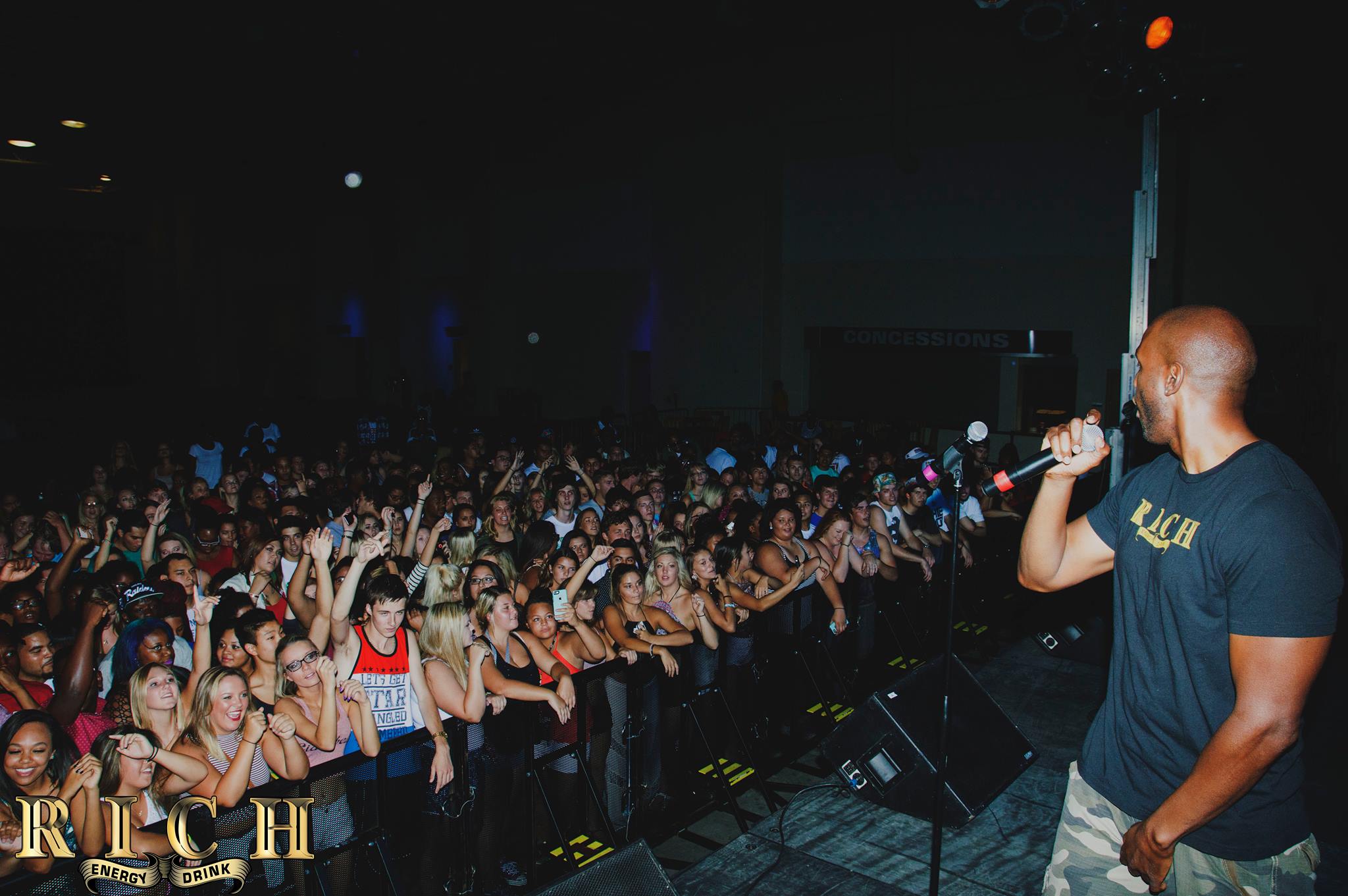 DJ Mista Soull performs before a large crowd at a night club.