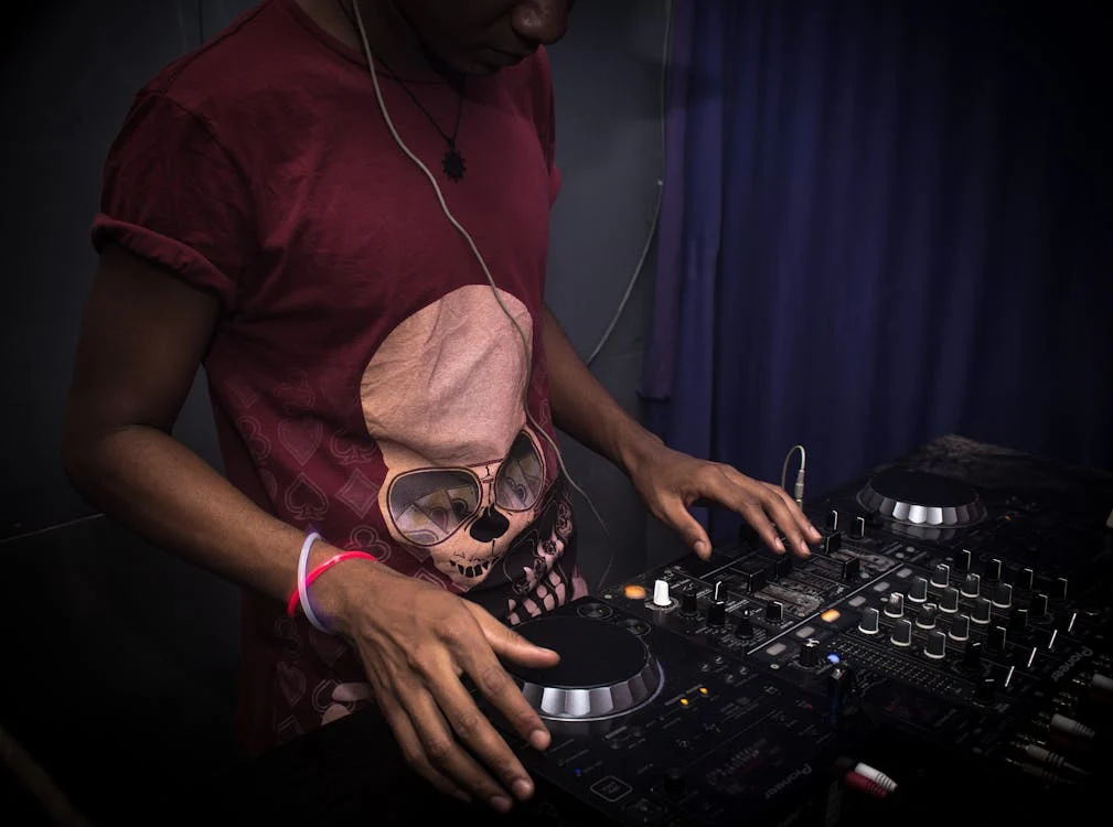 A young, new DJ putting on a show with his records.